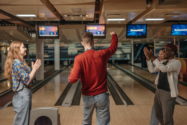 Company Outing; a group of people indulging in a game of bowling
