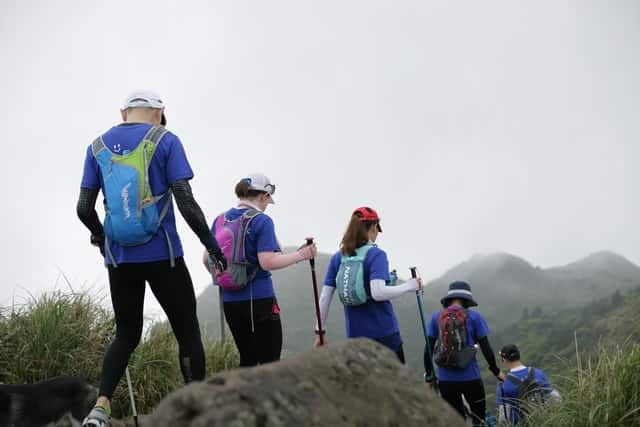 ways to reconnect with employees; a group of people in matching shirts taking a hike