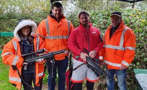 Clay Pigeon vs Air Rifle; a group of people posing with rifles in their hand