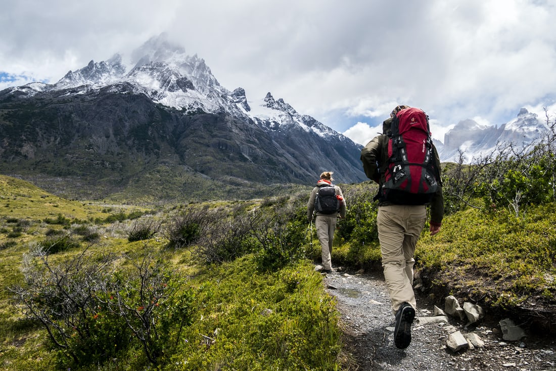 outdoor activities; 2 people walking on a mountain